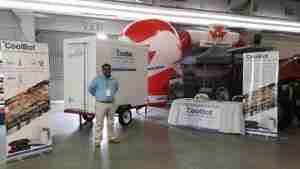 CoolBot demonstration booth at Expo AgroVision, featuring a mobile cooler, promotional banners, and a representative discussing cold storage solutions for farmers.